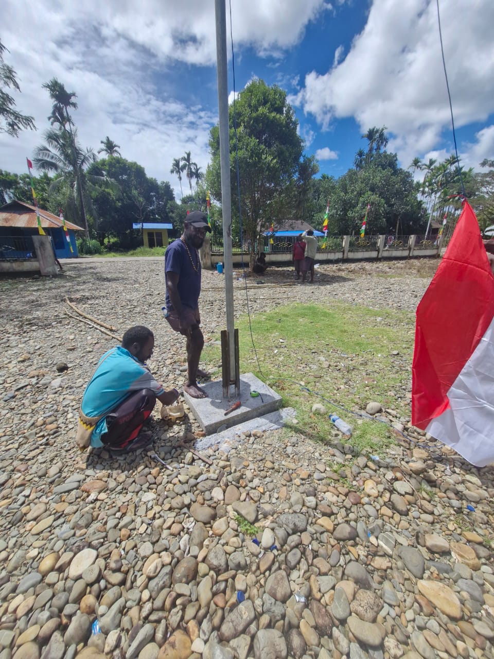 Warga saat mengikat bendera merah putih sebelum dikibarkan