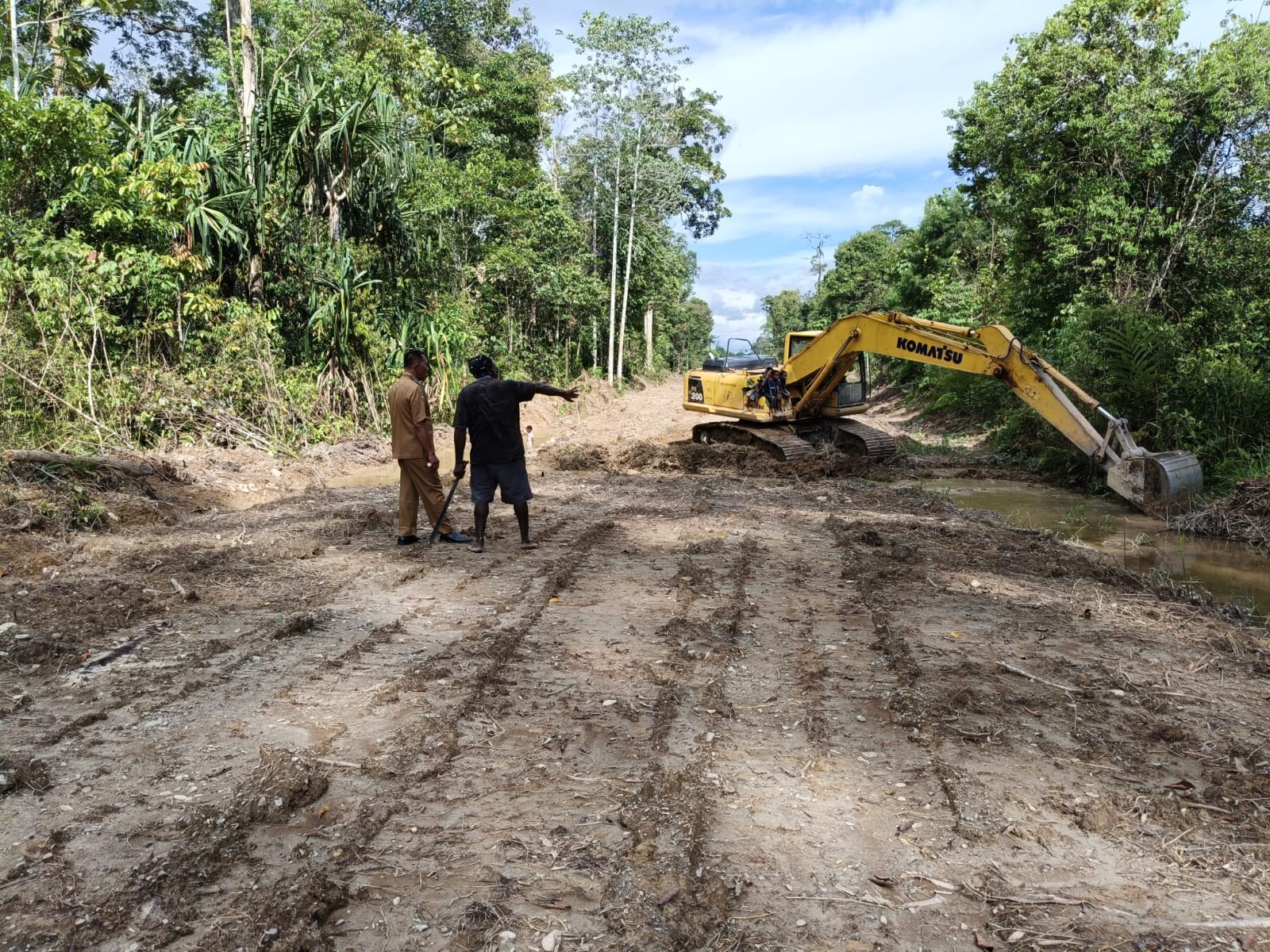 Kepala Kampung Karya Kencana Rakam Suntoro saat meninjau penimbunan jalan